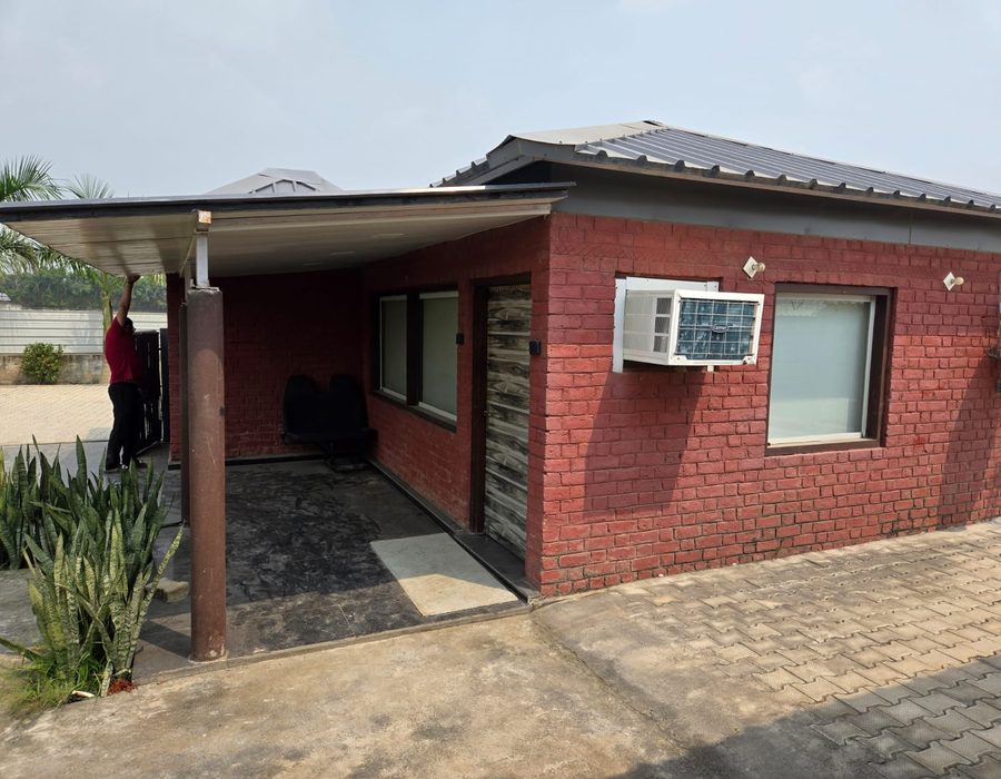 Brick cottage with covered carport at the farmhouse