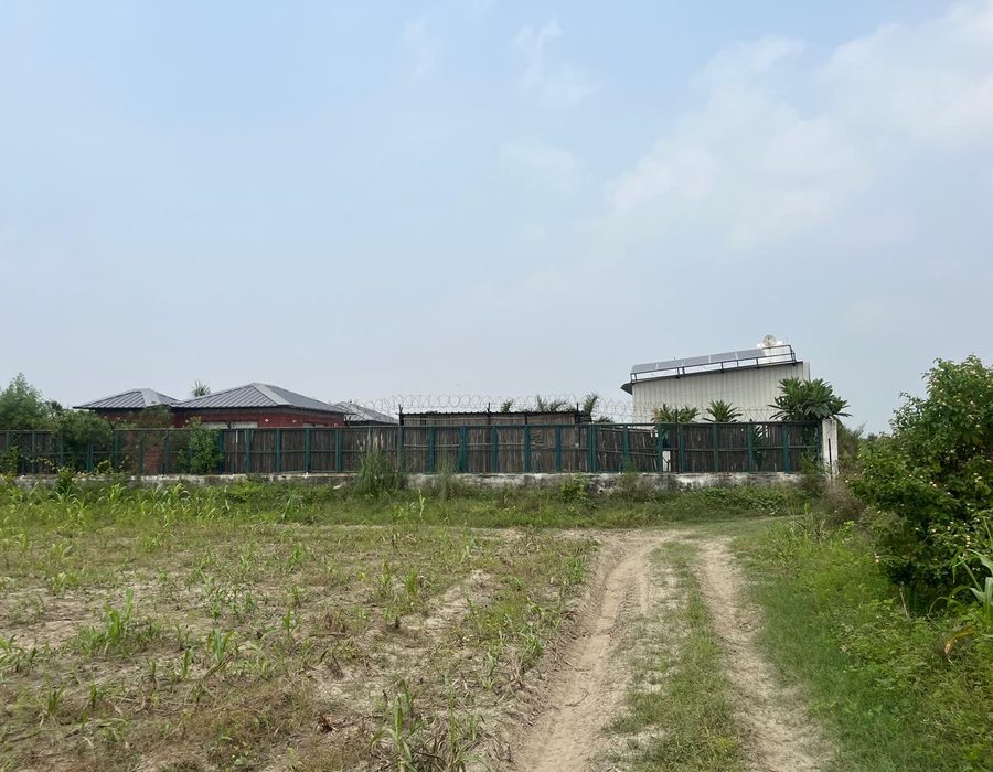 The farm compound seen from across the surrounding fields